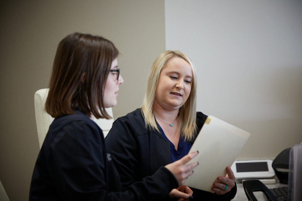 Summerville Oral Staff looking at dental charts