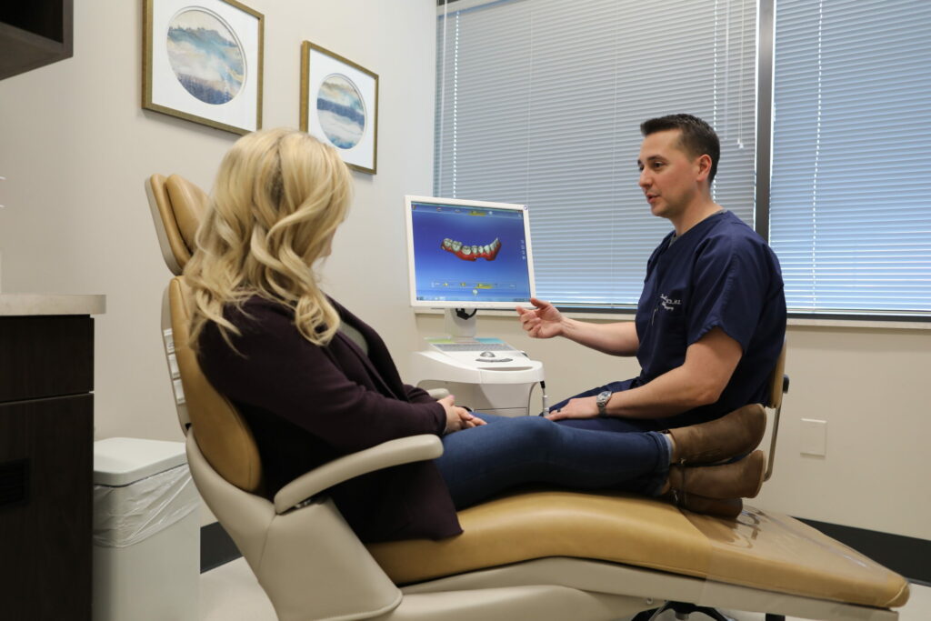 woman meeting with her oral surgeon to go over her oral surgery procedure