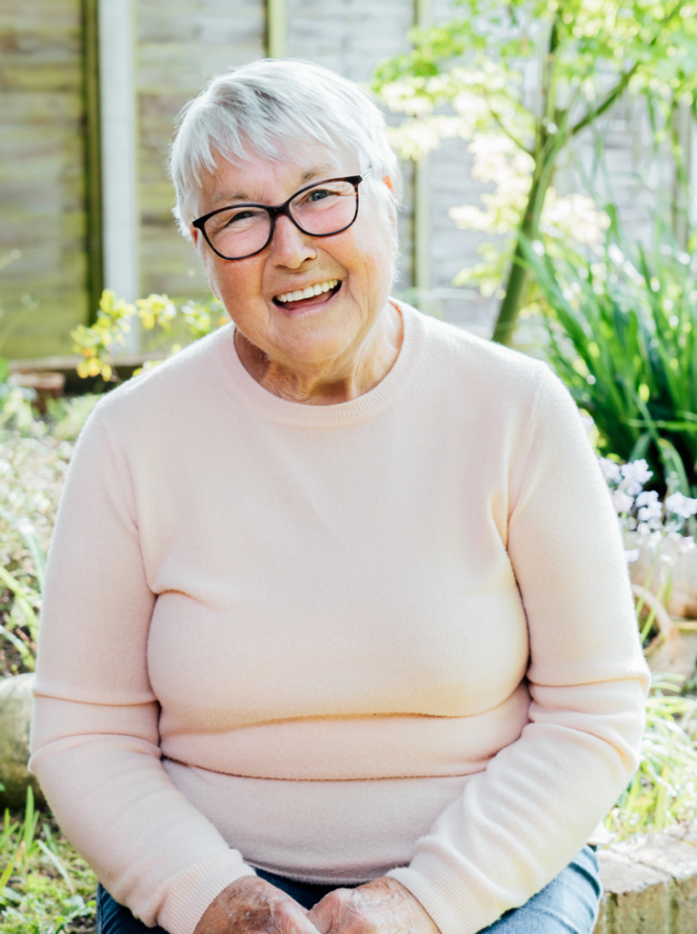 woman showing teeth in an hour dental implants